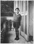 Emanuele Pacifici, a young Jewish boy makes the Fascist salute on the balcony of his house on Via Lanata.