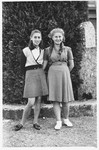 Two teenage girls pose together on the grounds of the Selvino children's home.