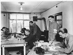 Men at work in the war crimes commission office established in Dachau.