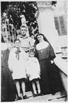 Shortly after liberation, three Jewish children pose with the Mother Superior of a convent where they had hid during the war.