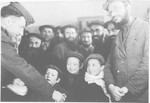 Rabbi Nathan Baruch, of the Vaad Hatzala, meets with young boys in the Pocking displaced persons' camp.