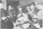 Rabbi Nathan Baruch, ,Rabbi Aviezer Burstein and a group of religious displaced persons sort through various religious articles.