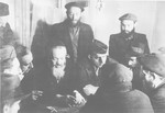 Rabbi Nathan Baruch meets with a group of religious men in the Pocking displaced persons' camp.