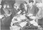 Rabbi Nathan Baruch, ,Rabbi Aviezer Burstein and a group of religious displaced persons sort through various religious articles.