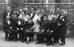 A German-Jewish family gathers for a group portrait to celebrate the wedding of Hugo Pauly and Selma Herz.