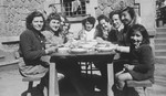 Jewish girls and teenagers eat outside in a courtyard in a postwar children's home in Feneyrols, France.