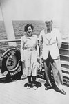 A Jewish couple poses next to a life preserver on the deck of the MS St.