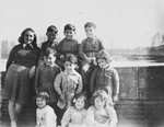 A Jewish teenager poses for a group portrait with the young children she is helping teach the alphabet to in Vic-sur-Cere.