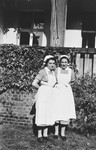 Two nurses in uniform pose outside the Berlin Jewish hospital.