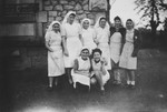 Group portrait Jewish teenage girls clad in nurses uniforms in the Limoges Pouponierre where they were assisting in the care of young children.