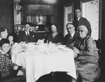 A Lithuanian Jewish family gathers around their dining room family.