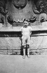 A young German-Jewish child poses by a large fountain in Wuerzberg.