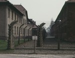 View of the main camp at Auschwitz surrounded by a section of the barbed wire fence.