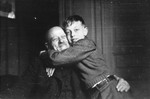 Olek gives his [grand]father a bear hug.