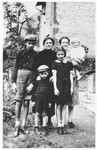 Group portrait of a Jewish family in Oswiecim. 

Pictured standing on the right is Helen Israel, who survived the war, carrying her son Leszek, who perished in Auschwitz in 1943.