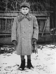 Portrait of a Jewish boy holding a skate in Sokal, Poland.