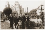 Representatives of the OSE (Oeuvre de Secours aux Enfants) pose with two members of the Buchenwald children's transport in the town square of Ecouis.