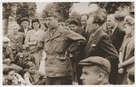 US Army Chaplain Rabbi Morris Dembowitz meets with members of the Buchenwald children's transport outside the Ecouis children's home.