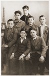 Group portrait portrait of Jewish children against a backdrop of the Eiffel Tower.