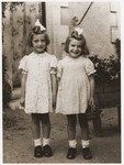 Two young Jewish sisters, Felice and Beate Zimmern, pose outside the home of Gaston and Juliette Patoux, the French couple who had sheltered them during the German occupation.