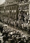 German troops parade through the streets carrying military banners during a Reichsparteitag (Reich Party Day) parade.