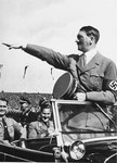Adolf Hitler salutes the ranks of German youth from his car during a Reichsparteitag (Reich Party Day) parade.