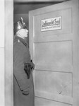 A member of the Schutzpolizei stands at the door of the Liebknecht Hall during the closing of the Karl-Liebknecht House, (KPD headquarters) which was on the Buelowplatz in Berlin.