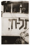 Two crew members of the Tel Hai look out the windows of their cabin.