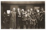 Group portrait of Youth Aliyah children from the Bergen-Belsen displaced persons camp in front of a train before their departure on the first leg of their journey to Palestine.