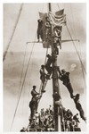 Illegal immigrants sailing to Palestine aboard the Tel Hai, climb the mast of the ship to hoist the Zionist flag.