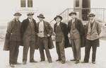A group of young Jewish men in jackets and ties pose outside a building in Bitola, Macedonia.