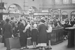 A group of Jewish children from Germany are reunited with their families at the train station in Berlin after their stay at a Kinderlager [children's recreational summer camp] in Horserod, Denmark.