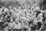 A crowd of people waves goodbye to the Jewish children from Germany as they depart from a Kinderlager [children's recreational summer camp] in Horserod, Denmark.