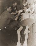 American medics treat an emaciated soldier, Pvt. Alvin L.