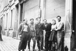 Group portrait of members of the Kibbutz Buchenwald hachshara on a street in Antwerp while waiting for passage to Palestine.