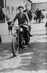 Young DPs ride a motorcycle along a thoroughfare in Schlachtensee displaced persons camp.