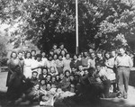 Group portrait of members of Kibbutz Buchenwald.

Mayer Abramowitz is pictured in the center wearing a military uniform.