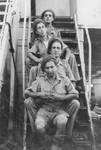 Abba Kovner, disguised as a Jewish Brigade soldier, poses with three others on the steps of the ship that was to take him back to Europe after completing his mission to Palestine on behalf of the Nekama organization.
