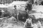 Four Jewish boys dig with shovels at a summer camp for Jewish DP children in the Grunewald Forest.