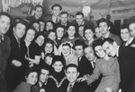 A group of Jewish DPs who are students at a teacher training center in Berlin, pose with one of their instructors and his bride at their wedding in the Schlachtensee displaced persons camp.