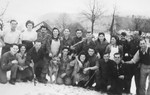 Group portrait of members of Kibbutz Buchenwald posing in the snow.