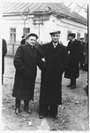 Shlomo Rachmil and a friend pose on a street corner in a small Russian town after liberation.