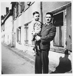 Hugo Odenheimer holds his young son Hugo and poses on a street in Buhl, Germany.