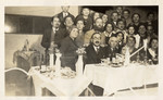 Group portrait of the employees of the Bialer textile factory attending a Passover seder together.