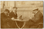 Three Jewish men play a game of cards in Vienna Austria.