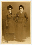 Studio portrait of two Jewish women in Finland,  wearing winter coats and hats.