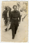 A recent immigrant walks down a street in Tel Aviv in his army uniform.