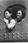 Jewish refugees look out through the portholes as they arrive in Haifa harbor.