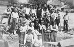 Group portrait of Jewish forced laborers holding shovels in Kolbuszowa.