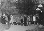 Premysl Pitter (left) poses with a group of young DP children living in one of "The Castles" children's homes he established along with Olga Fierzova.